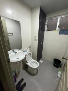 a bathroom with a toilet and a sink at AYAAN Flora Quintet Apartment & Fifa Home 4 with Free Parking in Tanah Rata +32 photos