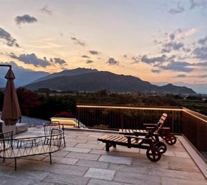 a patio with a bench and a table and a chair at Agriturismo Arezza in Revello