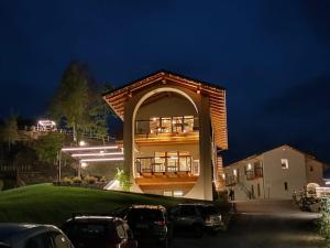 a building with an archway in a parking lot at night at Agriturismo Arezza in Revello