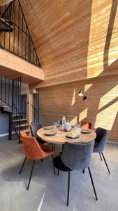 a dining room with a table and chairs at Arboreal Retreat in Văleni +16 photos