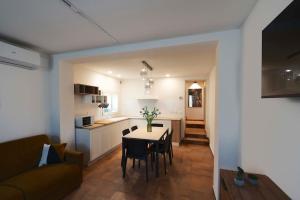 a living room and kitchen with a table and chairs at Ca' del Maglio in Cison di Valmarino