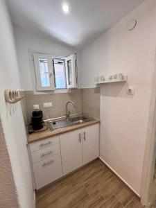 a small kitchen with a sink and a counter at Estia Rooms in Olympiada