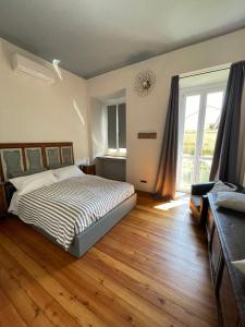 a bedroom with a bed and a large window at La Reggia di Famiglia in Venaria Reale