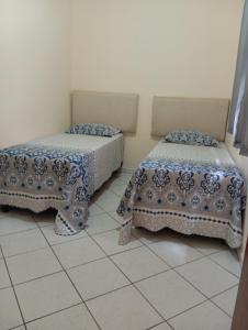 a room with two beds and a tiled floor at Chácara celebrar in Pirenópolis +16 photos