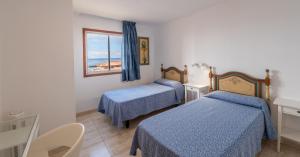 Postel nebo postele na pokoji v ubytování Torres del Sol - Los Cristianos