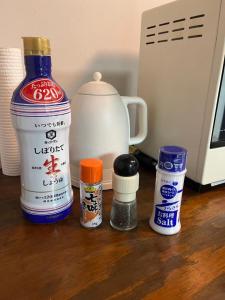 a counter top with a bottle of milk and spices at 甘口派room in Obanazawa