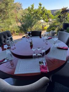 a round table with wine glasses and napkins at Genesis Boutique Hotel in Lusaka