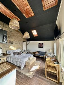 a bedroom with a bed and a stone wall at The Stonehouse Makers' Maisonette in Pictou