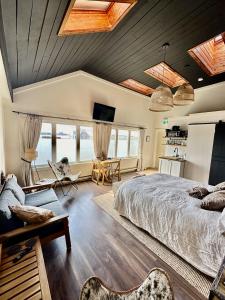 a bedroom with a large bed and a living room at The Stonehouse Makers' Maisonette in Pictou