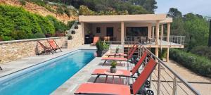 a villa with a swimming pool and a house at Les Hauts du Peireguier in La Motte