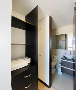 a bathroom with a black cabinet and a sink at Domus Suites Chia in Chía +223 photos