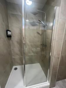a shower with a glass door in a bathroom at 2 bed apartment Liverpool city centre in Liverpool