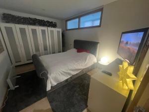 a bedroom with a bed and a desk with a television at 2 bed apartment Liverpool city centre in Liverpool