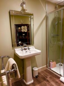 a bathroom with a sink and a shower at Clashmore House Garden Cottage Dornoch in Dornoch +34 photos