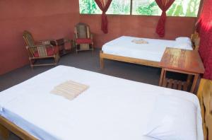 a room with two beds and two chairs in it at Maniti Eco-Lodge in Francisco de Orellana +20 photos