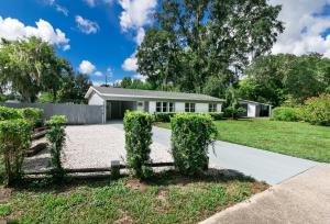 a house with a hedge in front of a driveway at The Oasis with New Salt Pool Close to Everything in Gainesville