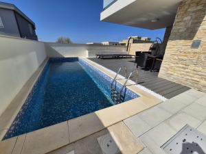 a swimming pool on top of a house at Lavir in Privlaka