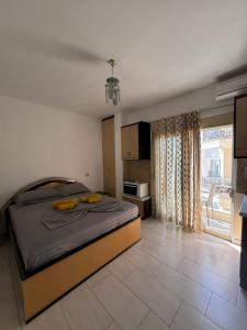 a bedroom with a bed with yellow pillows on it at Michal's Apartment in Sarandë