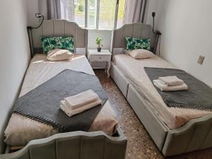 two beds sitting next to each other in a room at Playa del Pinar home in Grao de Castellón