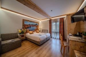 Postel nebo postele na pokoji v ubytování Hotel Panda Cortina- ricarica auto elettriche