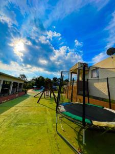 a playground in a school with a blue sky at Chácara Refúgio do Vinho in São Roque