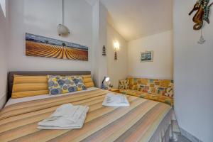 a bedroom with a large bed with two pillows at Mikelic Stara Barbariga in Barbariga +36 photos