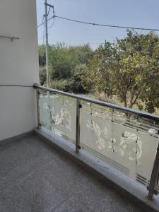 a balcony with a railing with a view at Iconic Royal Studio Apartment Near Expo Mart in CHI 5 in Greater Noida