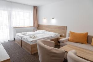 A bed or beds in a room at Hotel Toliar