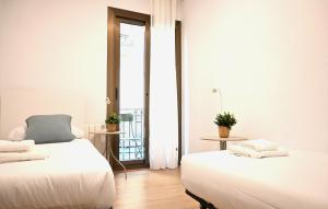 Ένα ή περισσότερα κρεβάτια σε δωμάτιο στο Homenfun Barcelona Avenida Diagonal