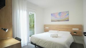 Postel nebo postele na pokoji v ubytování Hostal Calaya
