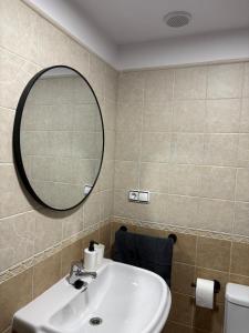 a bathroom with a sink and a mirror at Piso bajo con terraza in Mora de Rubielos +4 photos
