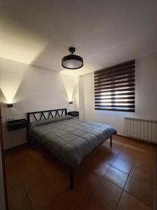 a bedroom with a bed in a room with a window at Piso bajo con terraza in Mora de Rubielos