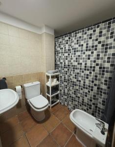 a bathroom with a toilet and a sink at Exclusive apartment with a terrace in Mora de Rubielos