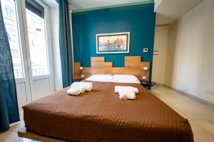 Posteľ alebo postele v izbe v ubytovaní CATANIA LIVING ROOMS