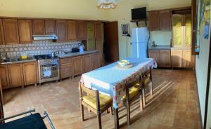 a kitchen with a table and chairs and a refrigerator at Casa San Rocco in Guardavalle