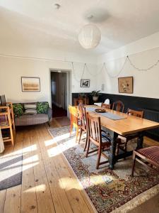 a living room with a wooden table and chairs at Augusta garden apartment in Sheringham