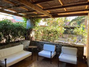 two chairs and a table on a patio at Casa MAREVERDE con aria condizionata in Punta Ala +10 photos