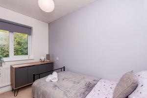a bedroom with a bed and a window at Modern 3 Bedroom Home in Swindon with Parking in Swindon