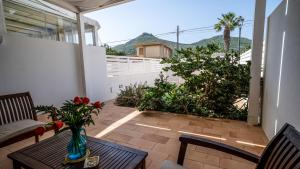 patio z wazą kwiatów na stole w obiekcie Villa Sapore di mare w mieście Favignana