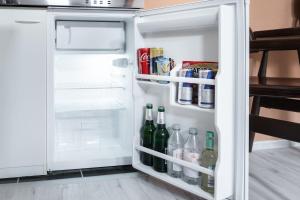 an open refrigerator filled with bottles and drinks at SchaeBu! 5 Apartment Altmarkt goes Afrika in Cottbus