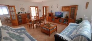 a living room with a couch and a table at Villa Sirena in Cala en Blanes
