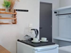 a kitchen with a tea kettle and cups on a counter at Georgia apartments in Stafylos