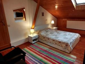 a bedroom with a bed and two night stands and a rug at Central Victoriei Guesthouse in Bucharest