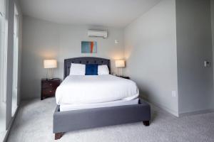 una camera da letto con un letto grande con due lampade di Luxury Private Apt with Pool a White Plains Altre 15 foto