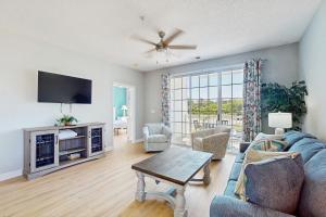 a living room with a couch and a tv at Palmy Days @ Ironwood 424 in Myrtle Beach