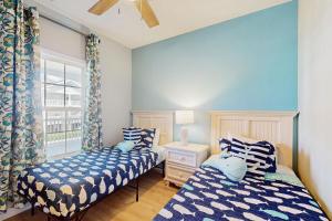 a bedroom with two beds and a window at Palmy Days @ Ironwood 424 in Myrtle Beach +14 photos