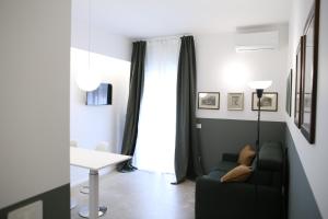a living room with a couch and a table and a window at Luca's Home in Trani