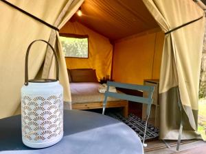 a tent with a table and a chair in it at CAMPING AMALASUNTA in Montefiascone