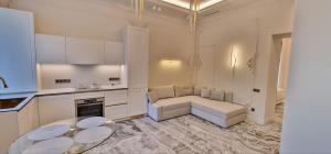 a kitchen with a couch and a table in a room at Ivory 1831 Boutique Apartment Luxury bath in Chişinău