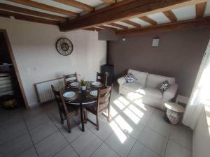 a living room with a table and a couch at Chez Mona in Florenville